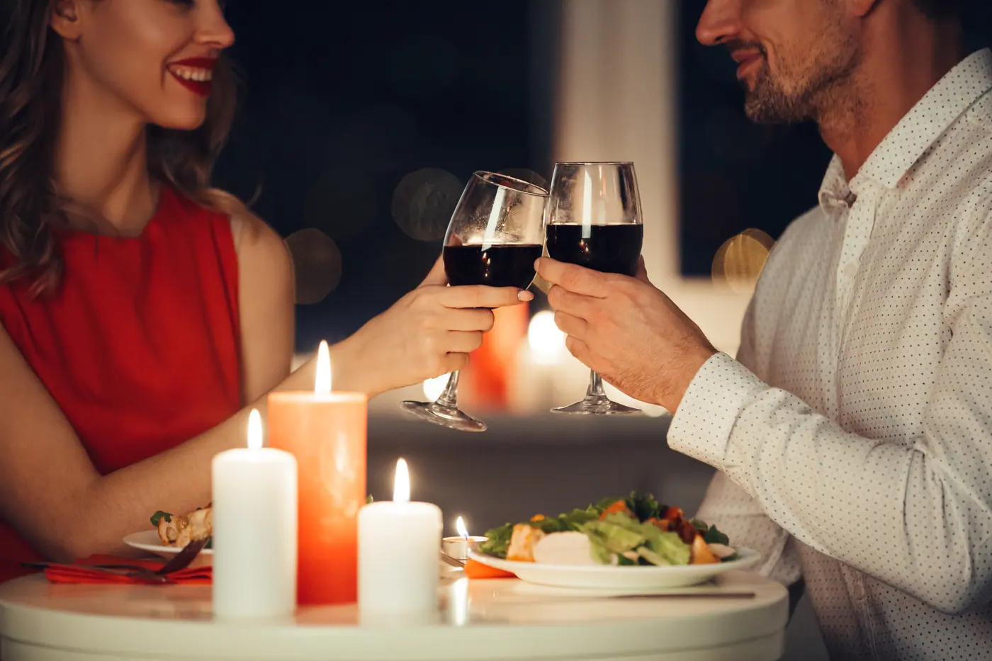 A couple sharing a romantic dinner together at home