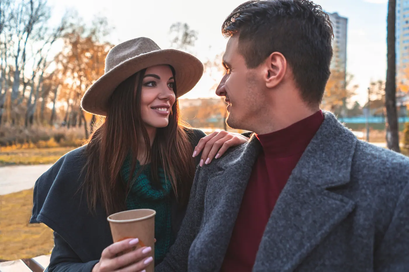 A couple enjoying coffee and conversation outdoors
