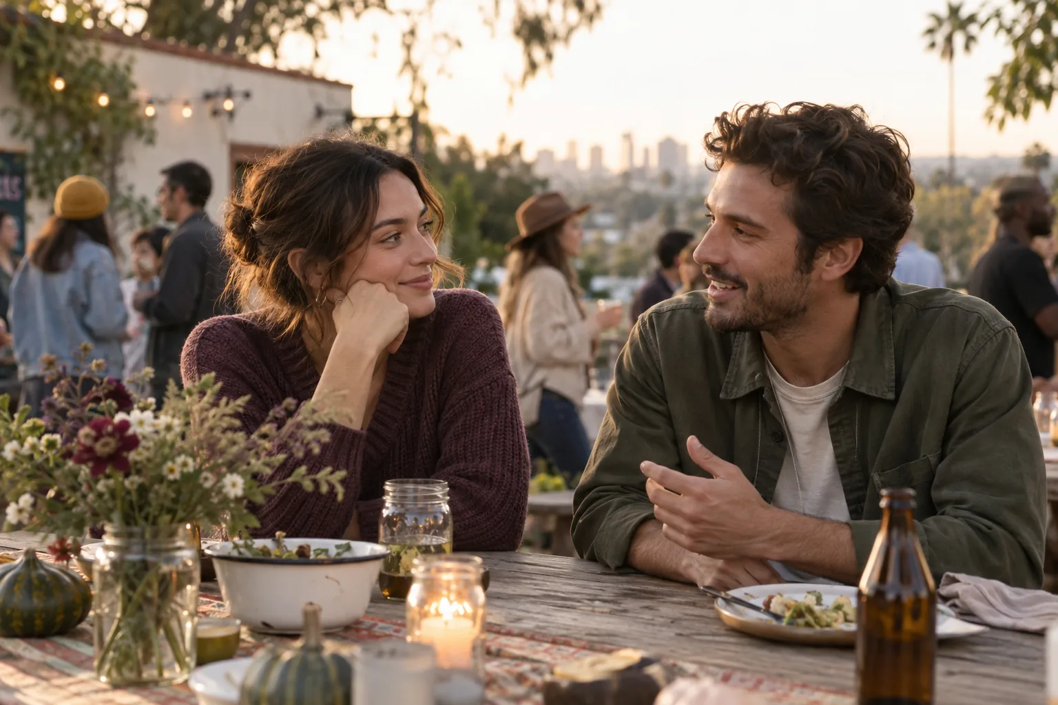 Two young adults talking at a relaxed outdoor community gathering